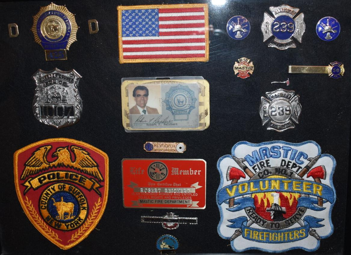 Robert Reichert's shields and badges from his days as a detective and volunteer firefighter